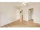 Bedroom view showcasing wood-look tile floors and open closet and doorway at 4922 W Fallen Leaf Ln, Glendale, AZ 85310