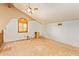 Spacious bedroom with large window, ceiling fan, and unfinished floors at 4922 W Fallen Leaf Ln, Glendale, AZ 85310