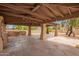 Spacious covered patio with stone flooring and ample space for entertaining and dining at 4922 W Fallen Leaf Ln, Glendale, AZ 85310