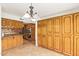 Dining area featuring wood cabinetry and tile flooring leading into the kitchen at 4922 W Fallen Leaf Ln, Glendale, AZ 85310