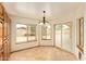 Inviting dining area with tile flooring, a chandelier, and lots of natural light at 4922 W Fallen Leaf Ln, Glendale, AZ 85310