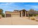 Wide driveway leading to a house with a three-car garage and well-kept landscaping at 4922 W Fallen Leaf Ln, Glendale, AZ 85310