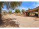 Wide driveway leading to covered patio and garage, surrounded by desert landscaping at 4922 W Fallen Leaf Ln, Glendale, AZ 85310