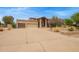 Wide driveway leading to a house with a three-car garage and well-kept landscaping at 4922 W Fallen Leaf Ln, Glendale, AZ 85310