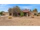 Well-maintained exterior with a three-car garage and desert landscaping for low maintenance at 4922 W Fallen Leaf Ln, Glendale, AZ 85310
