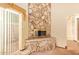 Close up on custom stone fireplace with sliding door in bright living room at 4922 W Fallen Leaf Ln, Glendale, AZ 85310