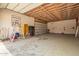 Spacious unfinished garage with ample room and roll up door. Exposed ceiling and plenty of room at 4922 W Fallen Leaf Ln, Glendale, AZ 85310