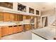 The garage features unfinished walls, fluorescent lighting, and custom cabinetry at 4922 W Fallen Leaf Ln, Glendale, AZ 85310