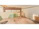 Unfinished garage features a window, ceiling beams, and a partially disassembled structure at 4922 W Fallen Leaf Ln, Glendale, AZ 85310
