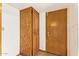 Hallway with wood-look cabinet and brown paneled door at 4922 W Fallen Leaf Ln, Glendale, AZ 85310
