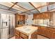 Bright kitchen featuring stainless steel appliances, a center island, and wood cabinetry at 4922 W Fallen Leaf Ln, Glendale, AZ 85310