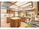 Spacious kitchen featuring custom wood cabinets, tile backsplash, and stainless steel appliances at 4922 W Fallen Leaf Ln, Glendale, AZ 85310