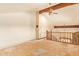 Large living room with high ceiling, wooden beams, and unfinished floors at 4922 W Fallen Leaf Ln, Glendale, AZ 85310