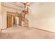 Spacious living room featuring a spiral staircase and open doorway at 4922 W Fallen Leaf Ln, Glendale, AZ 85310