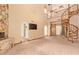 Bright Living Room with custom staircase, ceiling fans and stone fireplace at 4922 W Fallen Leaf Ln, Glendale, AZ 85310
