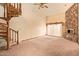 Bright Living Room with custom staircase, ceiling fan and stone fireplace at 4922 W Fallen Leaf Ln, Glendale, AZ 85310