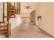 Bright Living Room with custom staircase, ceiling fan and stone fireplace at 4922 W Fallen Leaf Ln, Glendale, AZ 85310