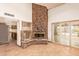 Living area boasting stone fireplace and access to the outdoor pool at 4922 W Fallen Leaf Ln, Glendale, AZ 85310