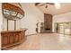 Open concept living room featuring a stone fireplace and wet bar at 4922 W Fallen Leaf Ln, Glendale, AZ 85310