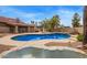 Beautiful backyard pool and waterfall feature, surrounded by a patio and landscaped area at 4922 W Fallen Leaf Ln, Glendale, AZ 85310