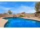Backyard pool with stone waterfall features and lush landscaping, perfect for outdoor entertaining at 4922 W Fallen Leaf Ln, Glendale, AZ 85310