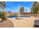 A backyard pool with a rock waterfall feature, spa and adjacent to an outdoor kitchen at 4922 W Fallen Leaf Ln, Glendale, AZ 85310