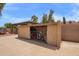 Pump house with gated access on a concrete pad with lush backyard landscaping and palm trees at 4922 W Fallen Leaf Ln, Glendale, AZ 85310