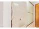 Shower with a glass door and a white tub at 4922 W Fallen Leaf Ln, Glendale, AZ 85310