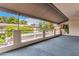 A covered balcony offers outdoor living with views of mature trees and neighboring architecture at 5200 S Lakeshore Dr # 206, Tempe, AZ 85283