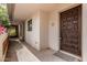 Inviting entrance featuring a dark wooden door and walkway to the home at 5200 S Lakeshore Dr # 206, Tempe, AZ 85283