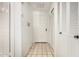 Bright hallway with white doors, tiled floor, and closet space at 5200 S Lakeshore Dr # 206, Tempe, AZ 85283