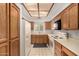 Functional kitchen with white appliances, wood cabinets, and plenty of counter space at 5200 S Lakeshore Dr # 206, Tempe, AZ 85283