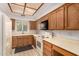 Efficient kitchen featuring wood cabinetry, white appliances, and tile flooring at 5200 S Lakeshore Dr # 206, Tempe, AZ 85283
