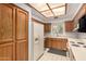 Functional kitchen features wooden cabinets, white appliances, and a window over the sink at 5200 S Lakeshore Dr # 206, Tempe, AZ 85283