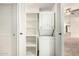 Laundry closet features stacked washer and dryer with shelving at 5200 S Lakeshore Dr # 206, Tempe, AZ 85283