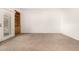 Spacious living room featuring neutral carpet, white walls, and built-in shelving at 5200 S Lakeshore Dr # 206, Tempe, AZ 85283