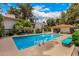 Community pool surrounded by lounge chairs and green spaces for residents to relax at 5200 S Lakeshore Dr # 206, Tempe, AZ 85283