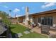 Inviting backyard with artificial turf, brick patio, outdoor furniture, and a charming brick chimney at 5231 E Tamblo Dr, Phoenix, AZ 85044