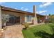 Backyard featuring a brick patio, artificial grass, and plenty of room for outdoor entertaining at 5231 E Tamblo Dr, Phoenix, AZ 85044