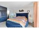 Primary bedroom with a round, upholstered bed, carpeted floors, and serene natural light, closet, and bathroom entrances at 5231 E Tamblo Dr, Phoenix, AZ 85044