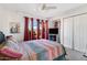 Bright bedroom featuring a ceiling fan, large windows, and comfortable bedding at 5231 E Tamblo Dr, Phoenix, AZ 85044