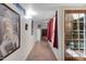 Hallway with unique tile flooring, artwork, and access to a glass-paneled patio door at 5231 E Tamblo Dr, Phoenix, AZ 85044