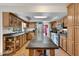 Spacious kitchen featuring custom cabinets, granite countertops, stainless steel appliances, and a large central island at 5231 E Tamblo Dr, Phoenix, AZ 85044