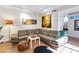 Comfortable living room with a sectional couch, artwork, and tiled floors, providing a cozy and stylish space at 5231 E Tamblo Dr, Phoenix, AZ 85044