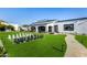 Well-maintained backyard with a giant chess set, lush lawn, and a paved walkway to the main house at 5404 N 41St St, Phoenix, AZ 85018
