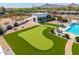 Aerial view of a backyard complete with putting green, luxurious pool, and outdoor entertainment area at 5404 N 41St St, Phoenix, AZ 85018