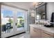 Bathroom offering direct access to an outdoor patio with a garden view, vanity, and shower at 5404 N 41St St, Phoenix, AZ 85018