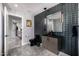 Bathroom with black tiled accent wall, marbled floors, modern lighting and black fixtures at 5404 N 41St St, Phoenix, AZ 85018