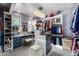 Chic closet featuring blue accents, vanity, ample shelf and hanging space, and a chandelier for added elegance at 5404 N 41St St, Phoenix, AZ 85018