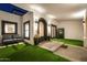 Inviting entryway with manicured lawn, outdoor seating, accent lighting, and charming arched doorway at 5404 N 41St St, Phoenix, AZ 85018